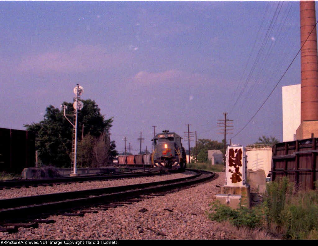 A southbound train awaits the arrival of a northbound at the south end of the yard